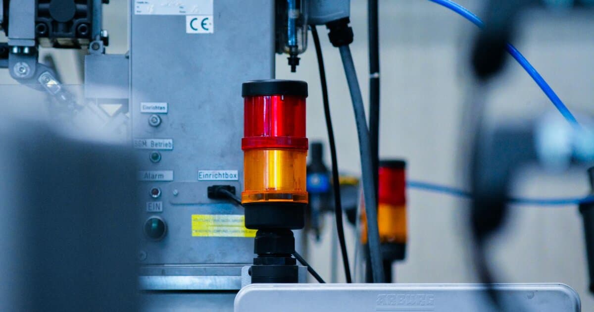 Detailed view of automated machinery with warning signals in an industrial setting.