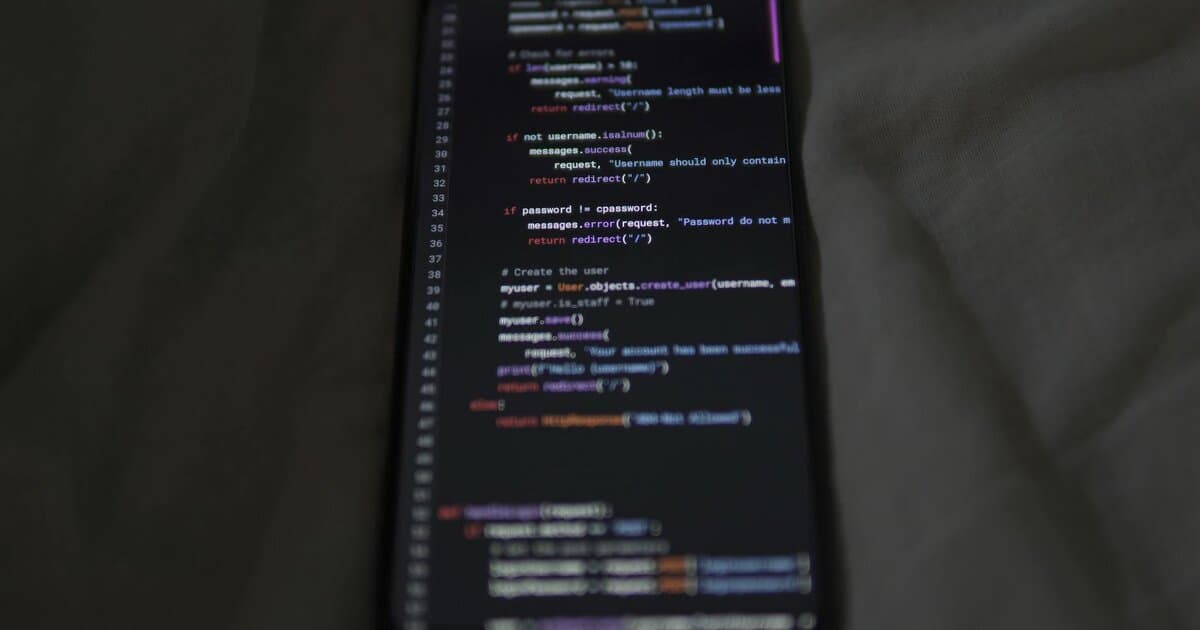 Close-up of a smartphone showing Python code on the display, showcasing coding and technology.