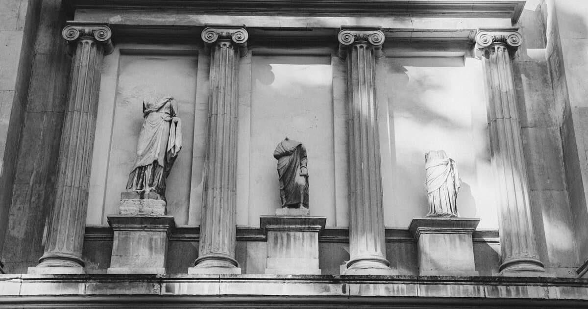 Black and white photo of a classic architectural facade with columns and statues.