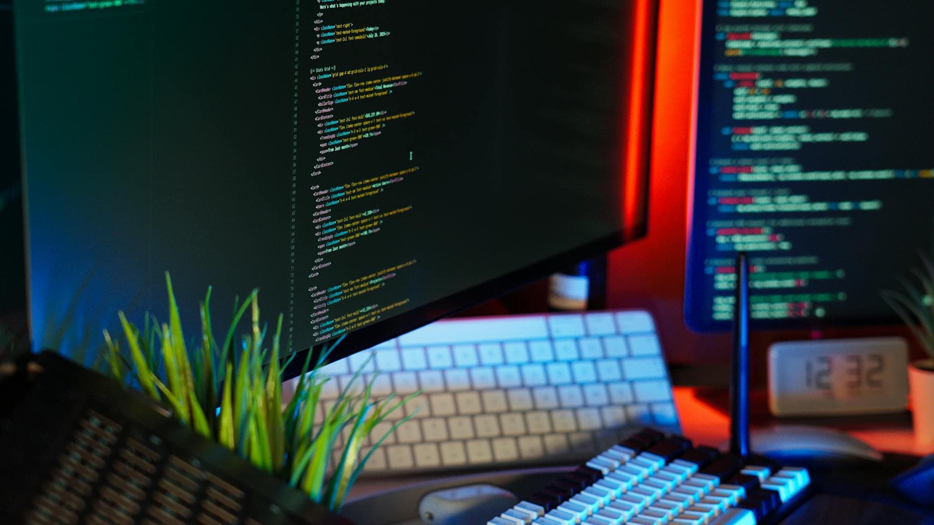 Developer workspace with code on multiple monitors