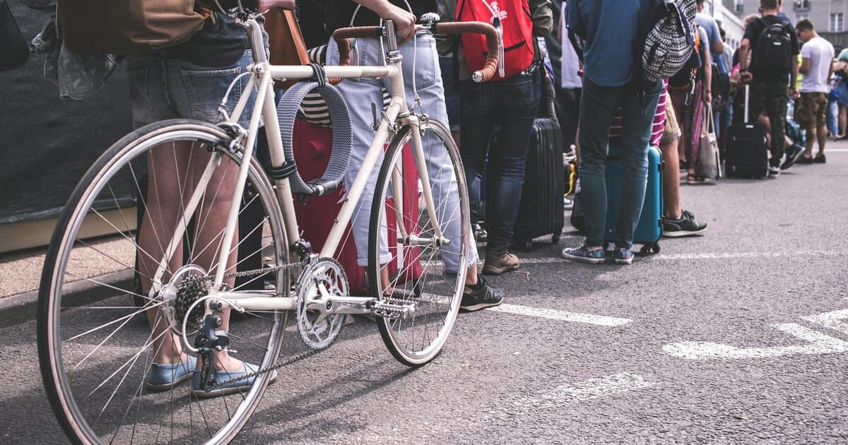 A diverse group of adults lined up in a city street, showcasing urban life.