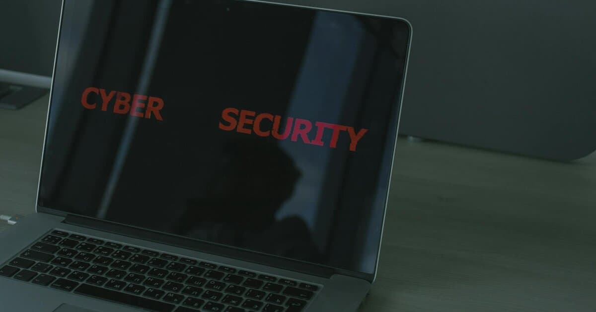 Close-up of a laptop displaying cybersecurity text, emphasizing digital security themes.