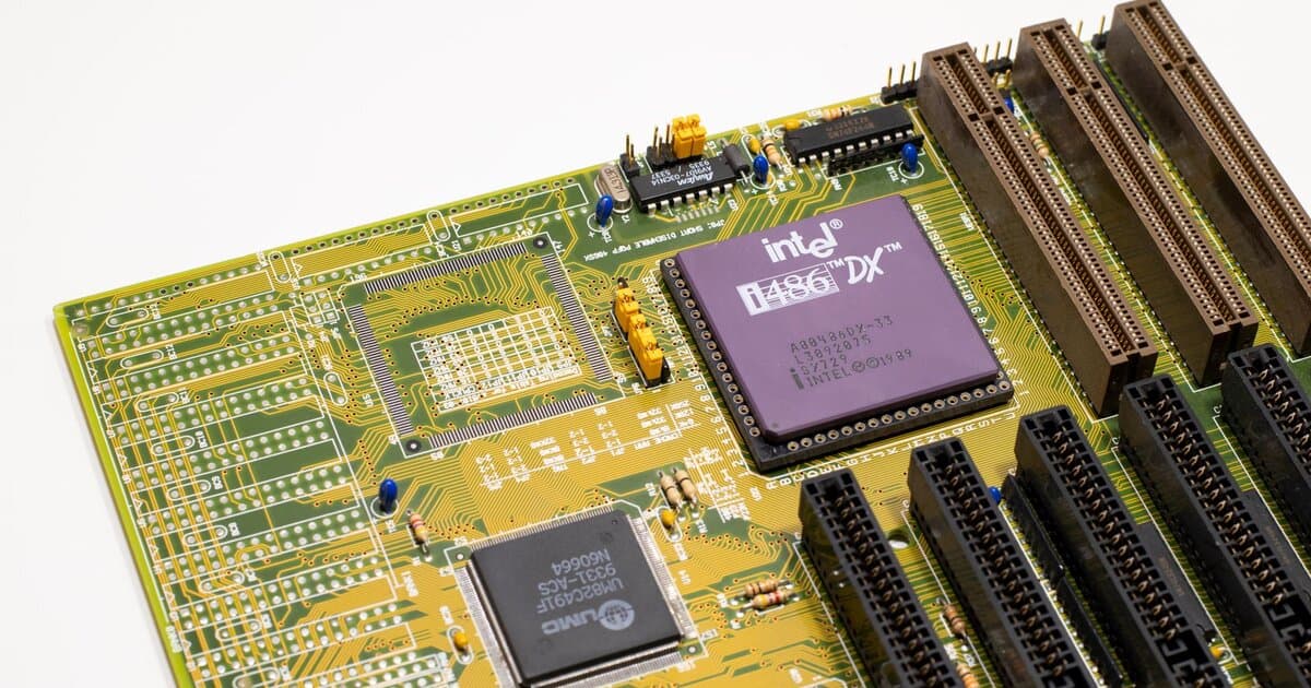 Close-up of a vintage Intel 486 CPU motherboard with PCI slots, highlighting retro technology components.