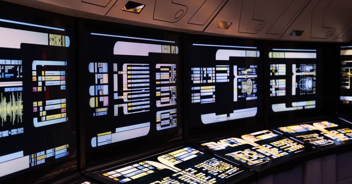 A high-tech command center with illuminated digital screens in a futuristic setting.