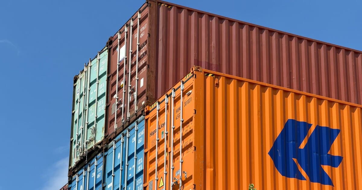 Colorful shipping containers stacked in an outdoor storage area in Germany.